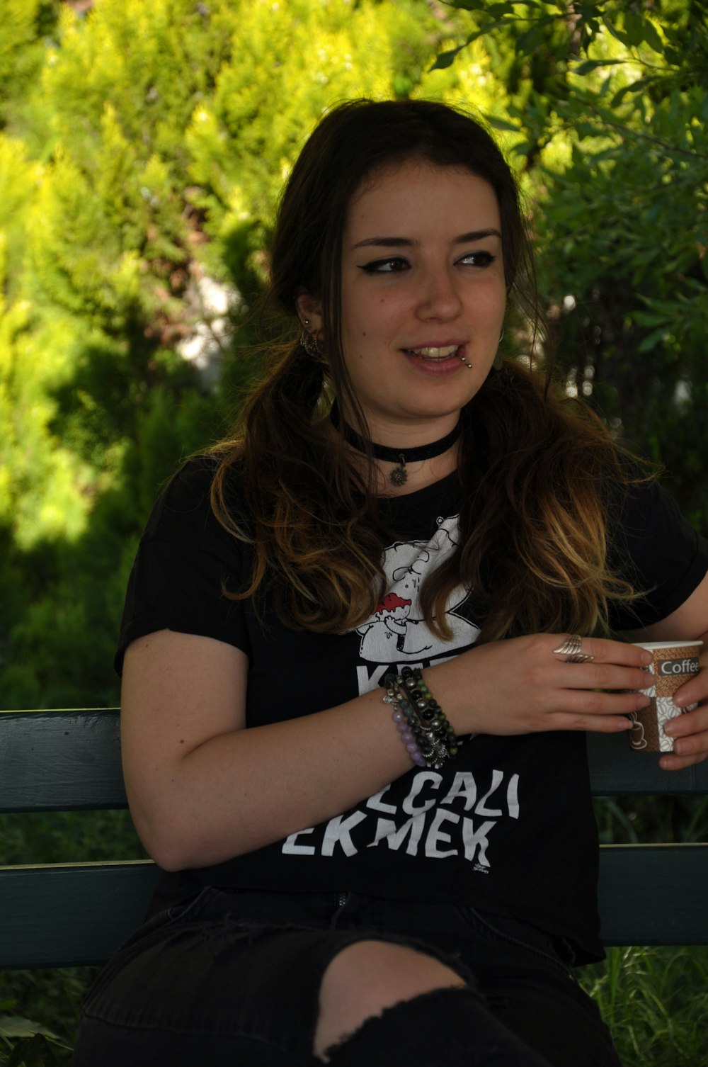 woman in black and white crew neck t-shirt sitting on bench