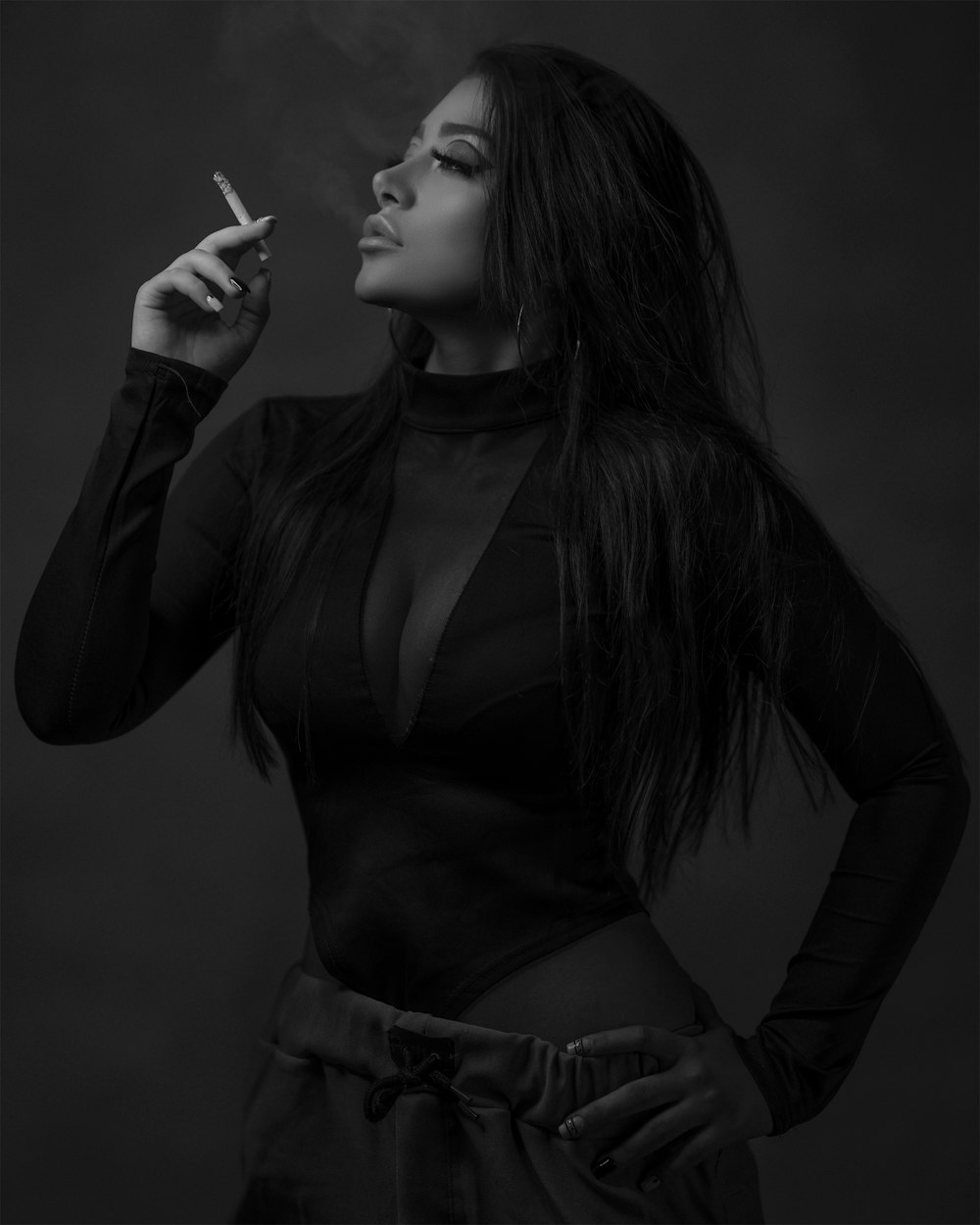 woman in black leather jacket smoking cigarette