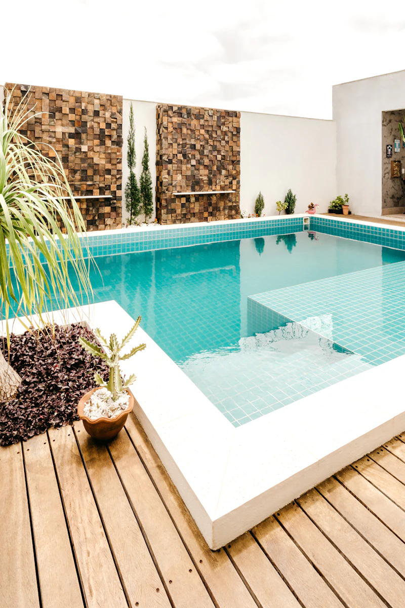 Potted plants beside a clear blue pool