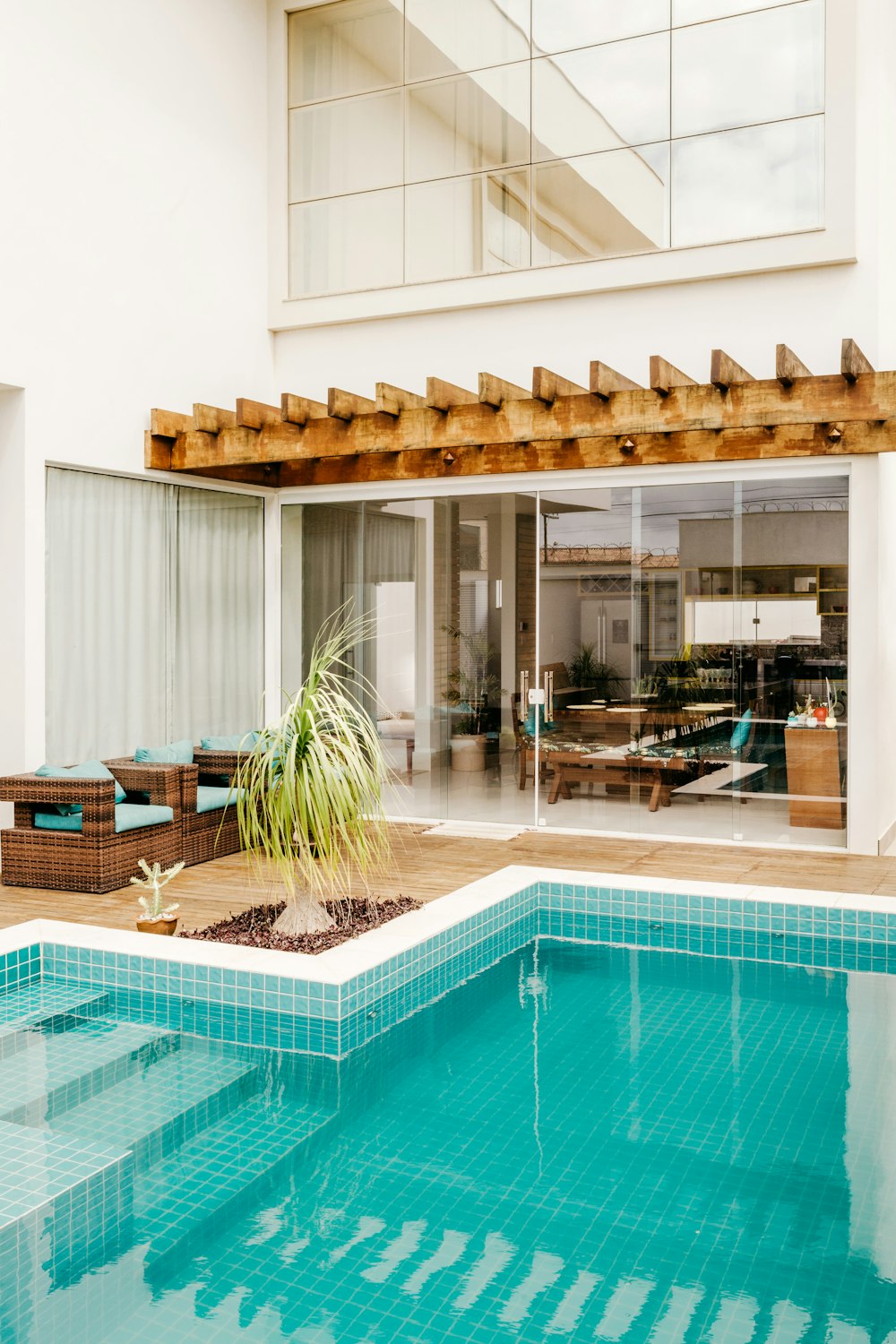 brown wooden chairs near swimming pool