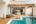 brown wooden table near swimming pool