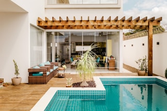 brown wooden table near swimming pool