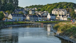 white and brown concrete houses near river during daytime
