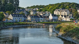 white and brown concrete houses near river during daytime