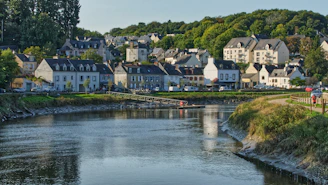 white and brown concrete houses near river during daytime
