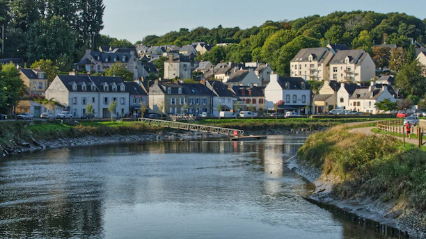 white and brown concrete houses near river during daytime
