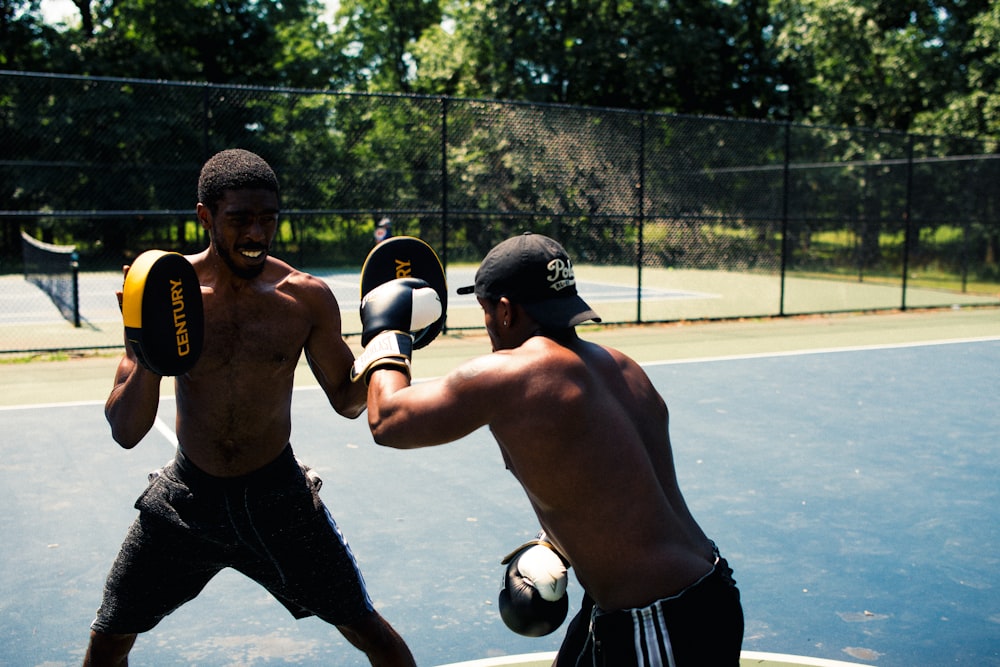 2 men playing soccer during daytime