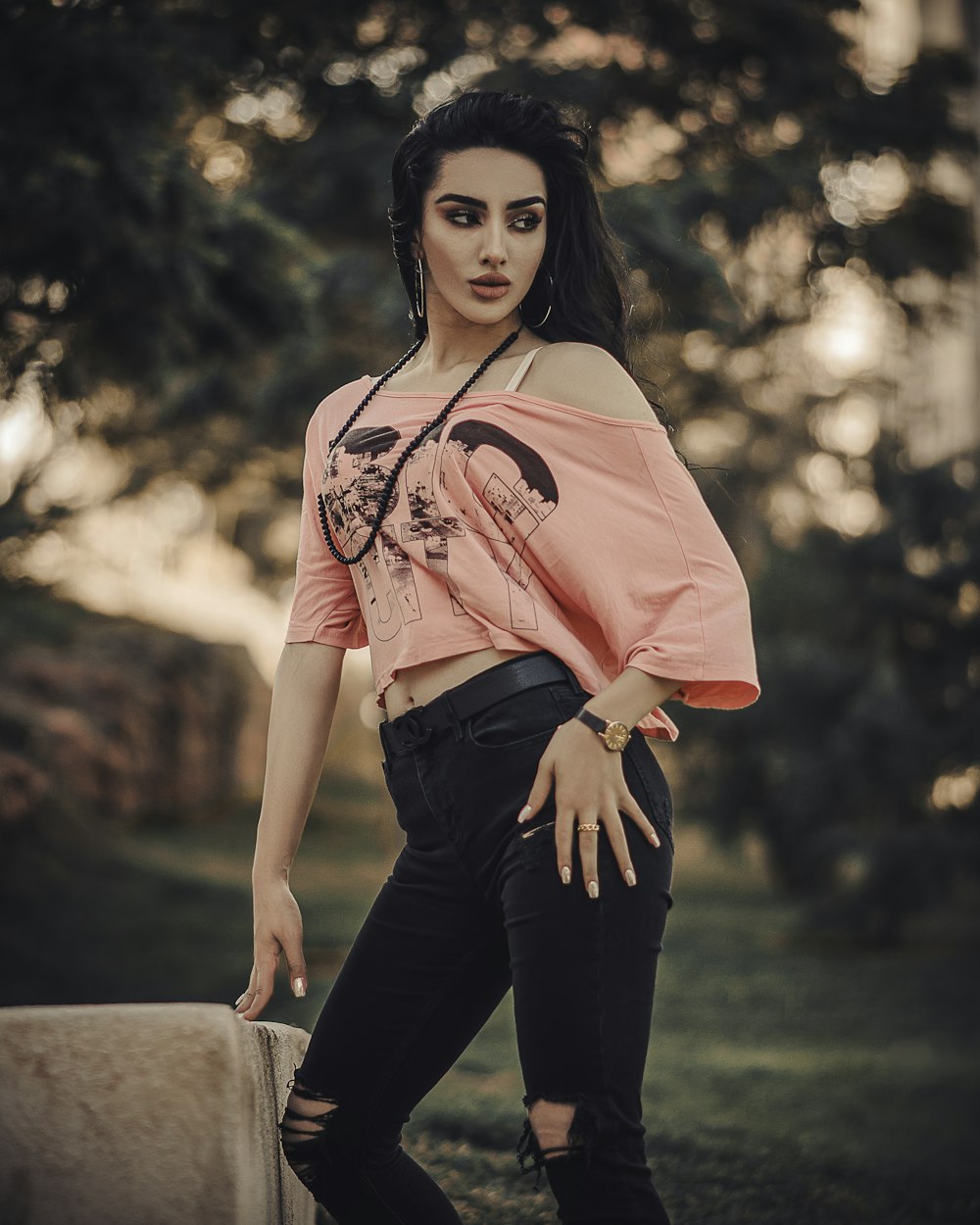 woman in pink long sleeve shirt and black pants