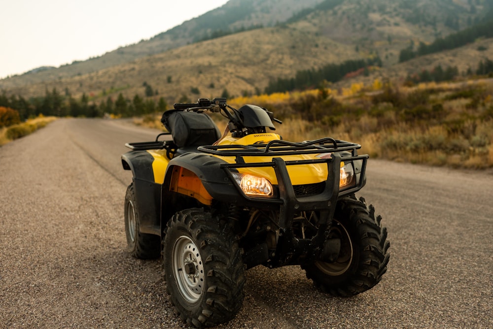 yellow and black atv on dirt road during daytime