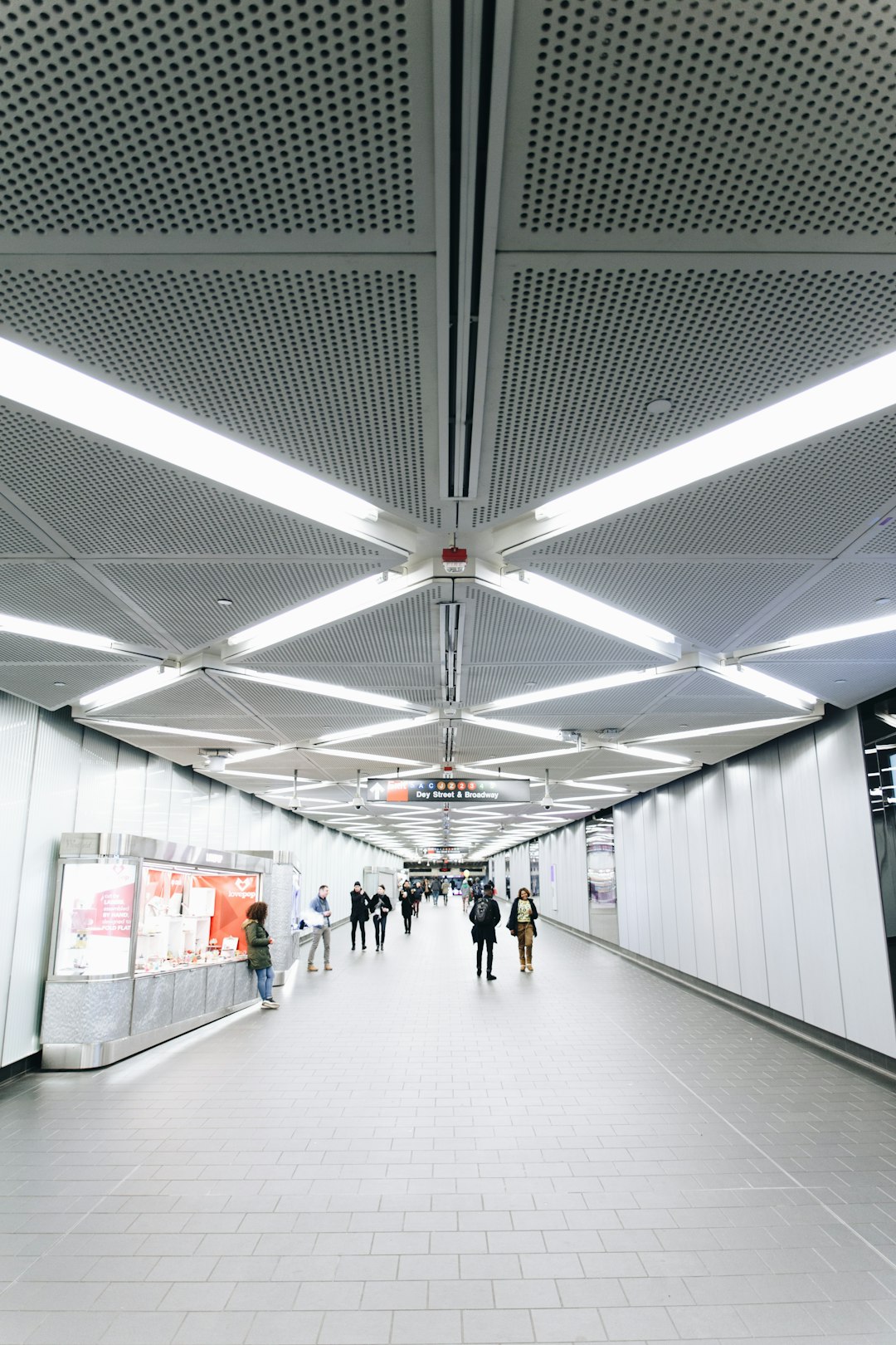 people walking on white hallway