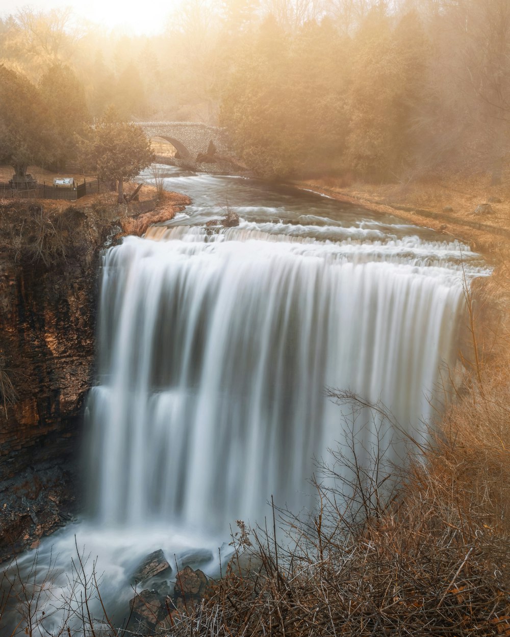 waterfalls in brown field during daytime