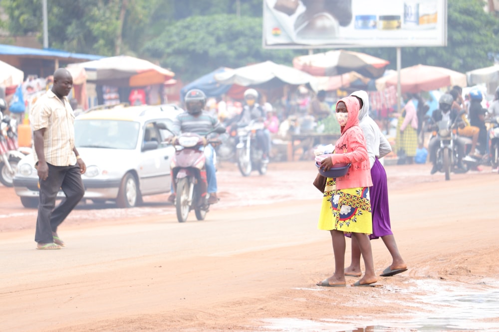 woman in yellow and pink dress holding yellow handbag walking on street during daytime