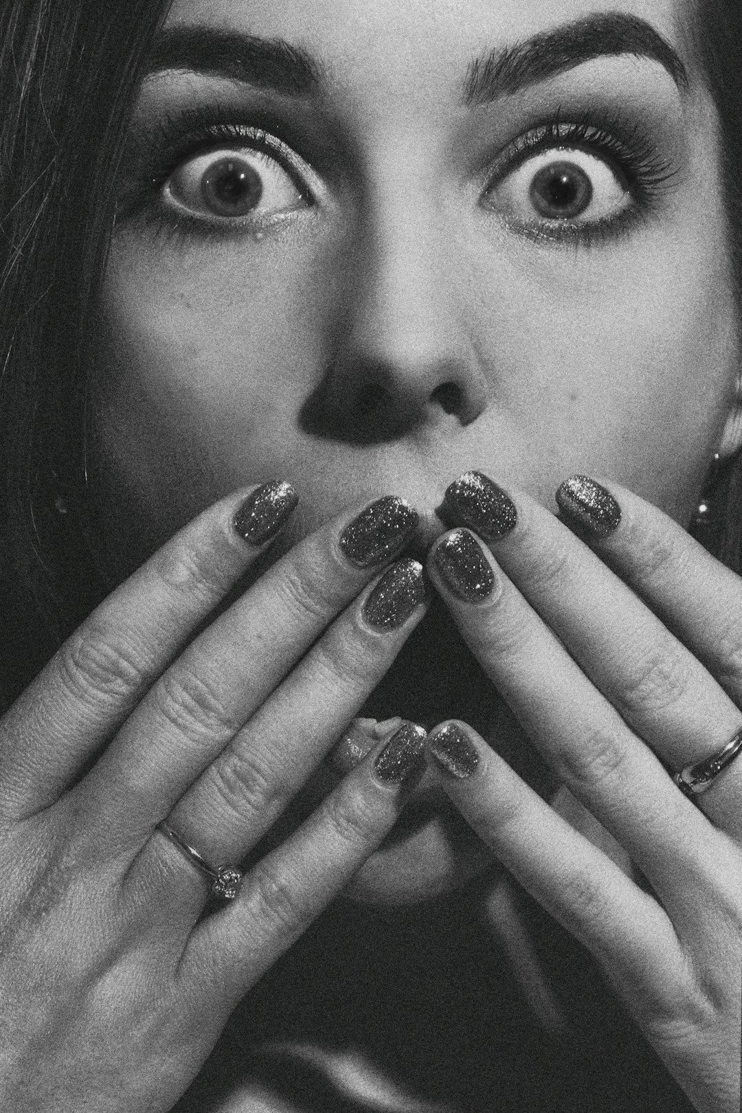 grayscale photo of woman with silver ring