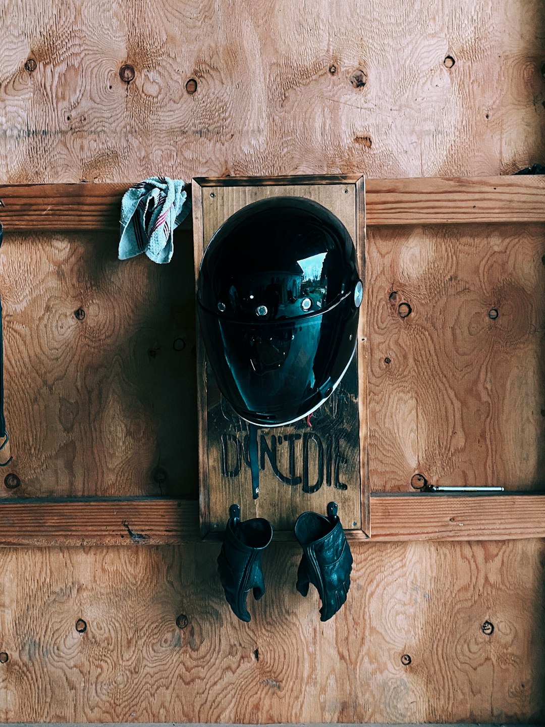 black helmet on brown wooden door