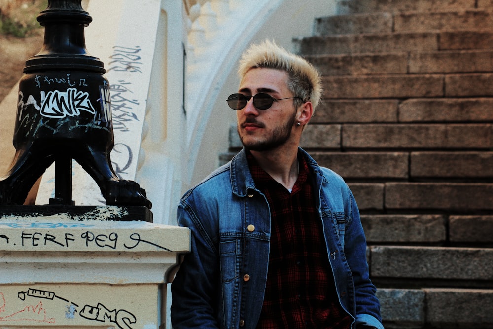 man in blue denim jacket wearing black sunglasses