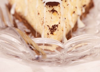 brown and white cake on clear glass plate