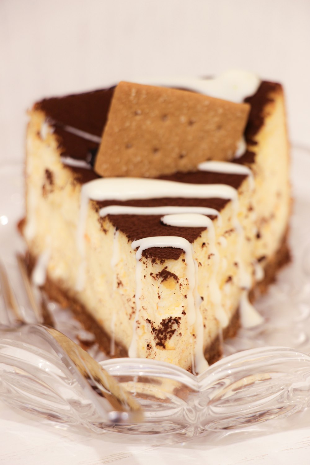 brown and white cake on clear glass plate