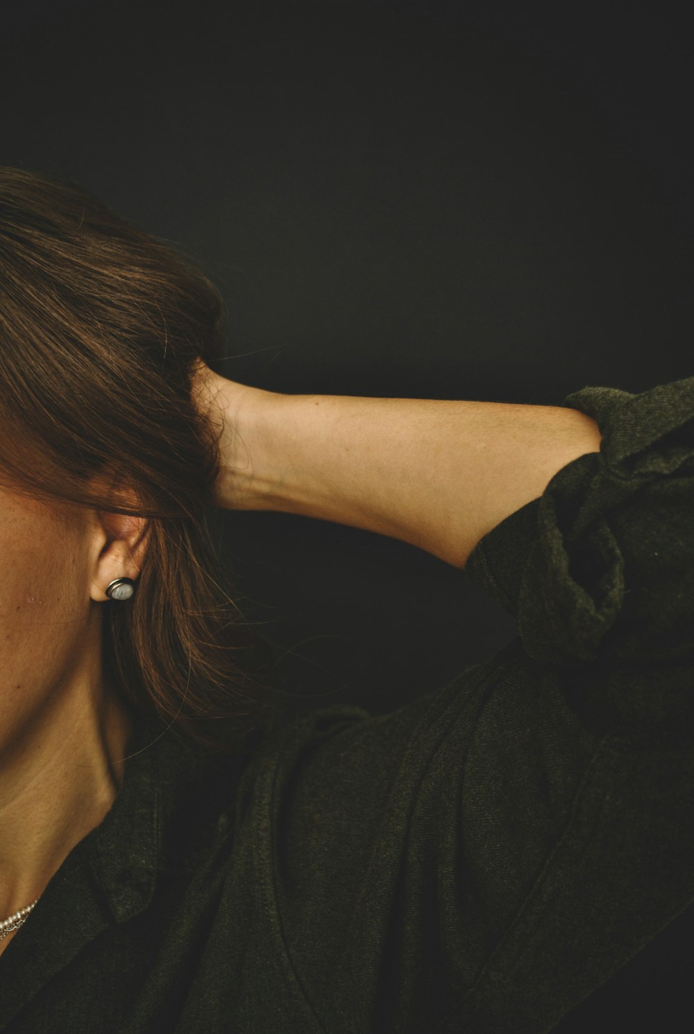 woman in black shirt wearing white earbuds