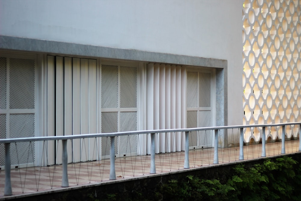 white concrete building with white metal fence