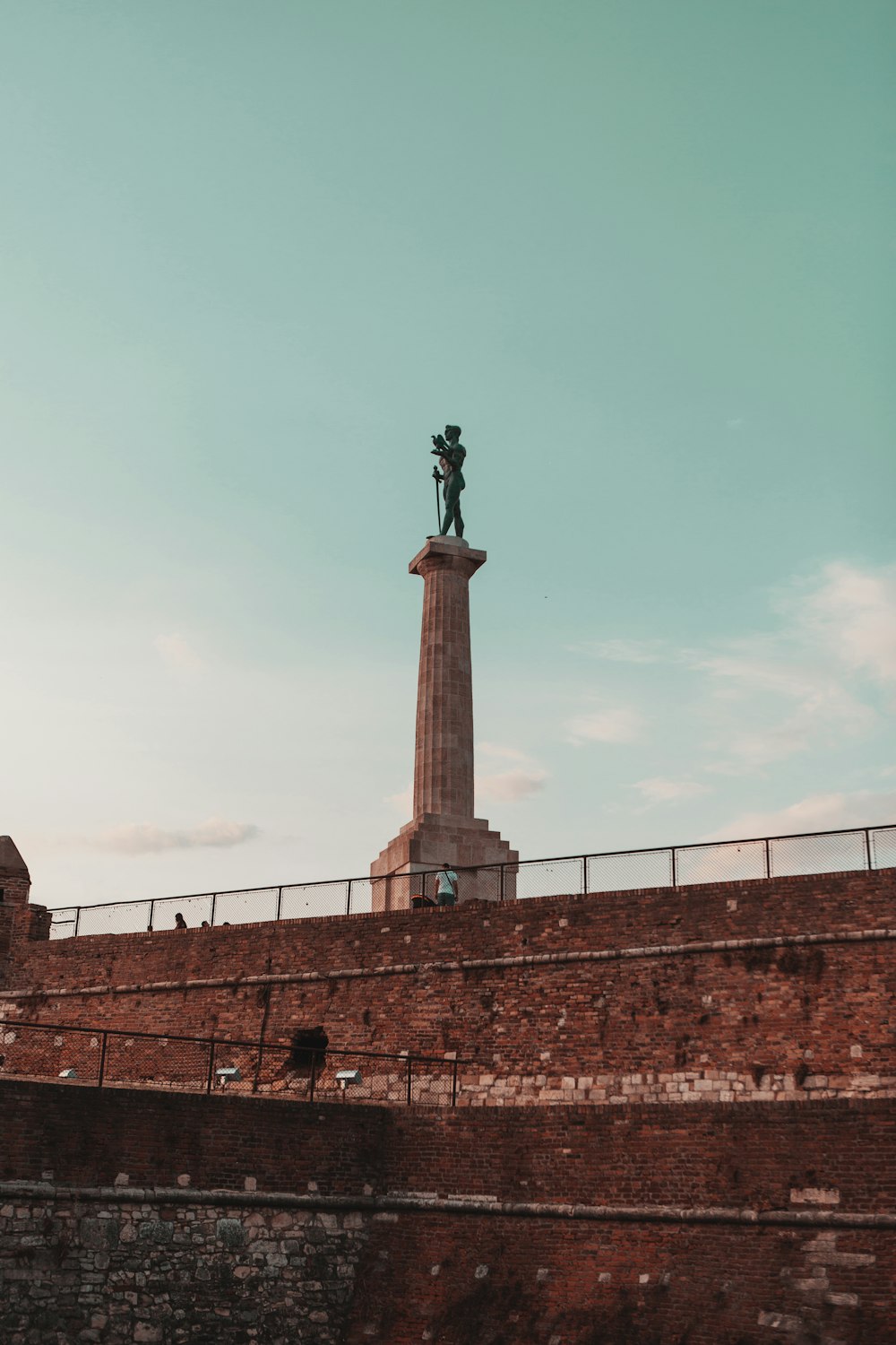 statue of man on top of building