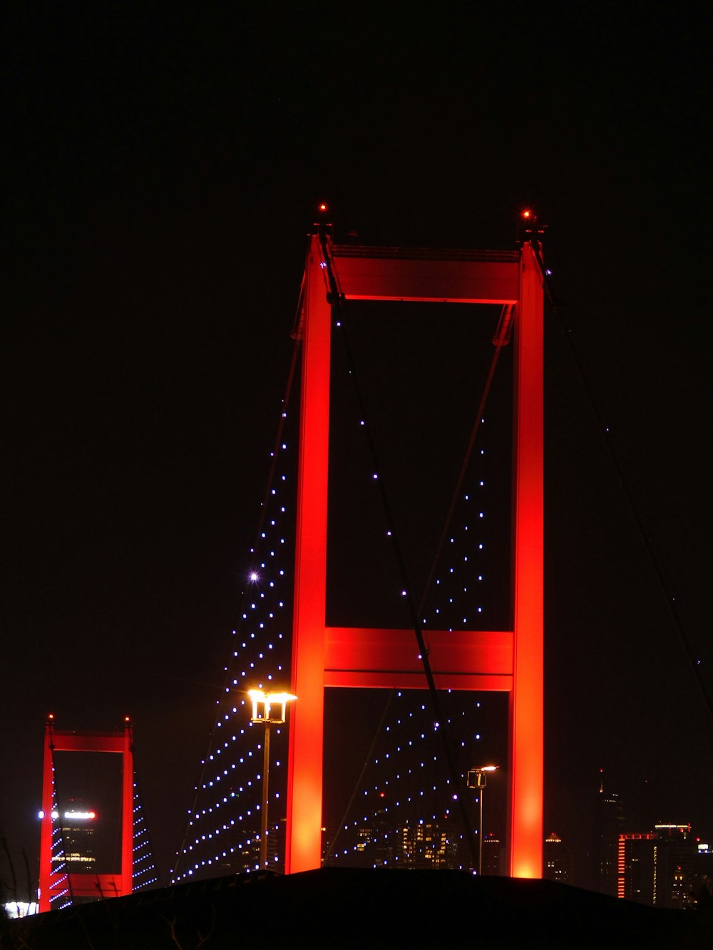orange bridge with lights during night time