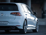A compact white hatchback ready for city driving with Nairobi skyline behind.