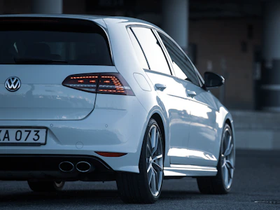 A compact white hatchback ready for city driving with Nairobi skyline behind.