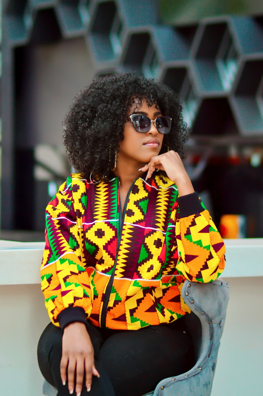 woman in yellow and black jacket wearing sunglasses
