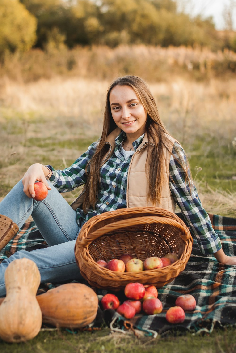 woman in blue denim jeans sitting on brown woven basket