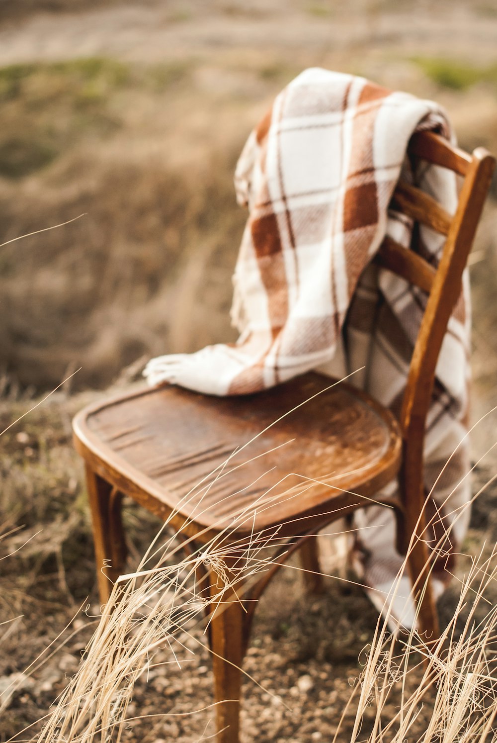 brown wooden chair on grass field