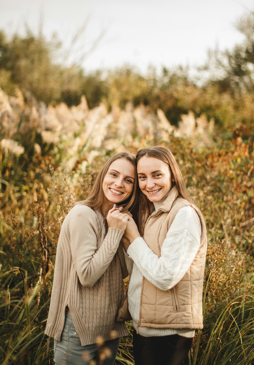 woman in white long sleeve shirt hugging woman in white long sleeve shirt