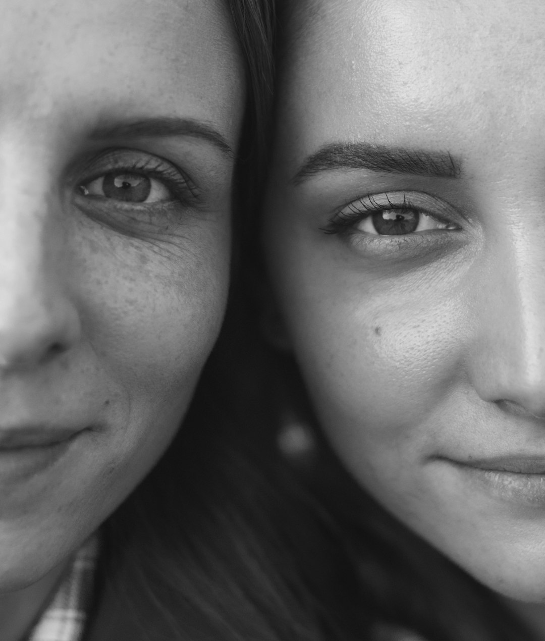 woman and man smiling in grayscale photography