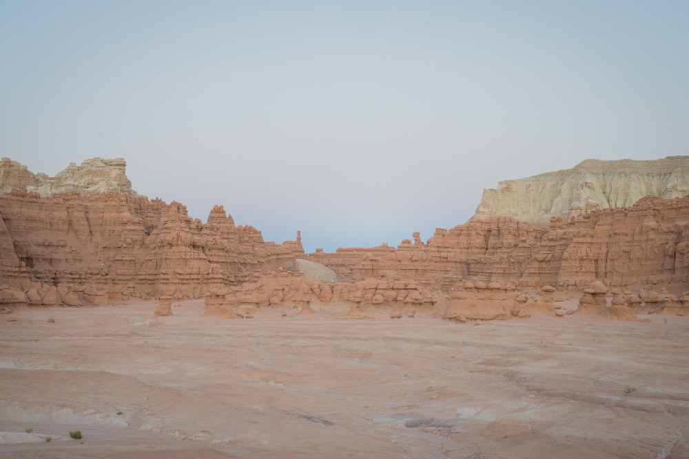 brown rock formation under white sky during daytime