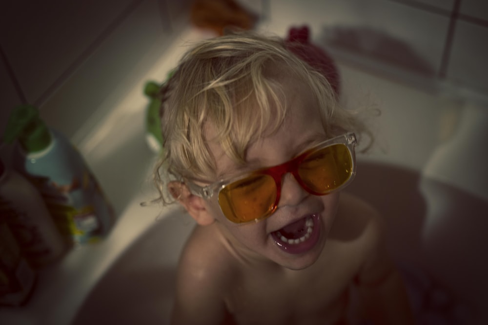 girl wearing orange framed sunglasses