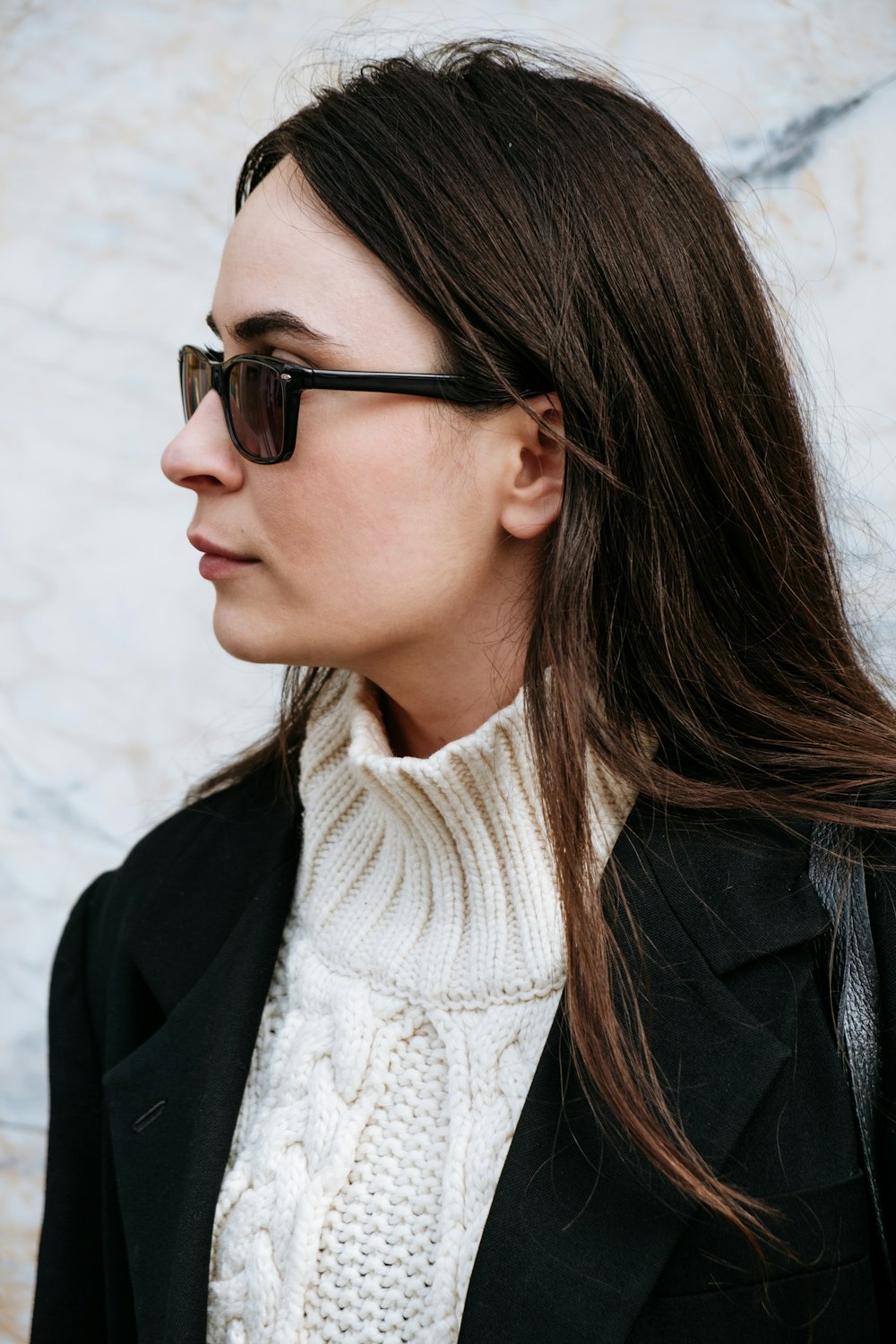 woman in black jacket wearing black sunglasses