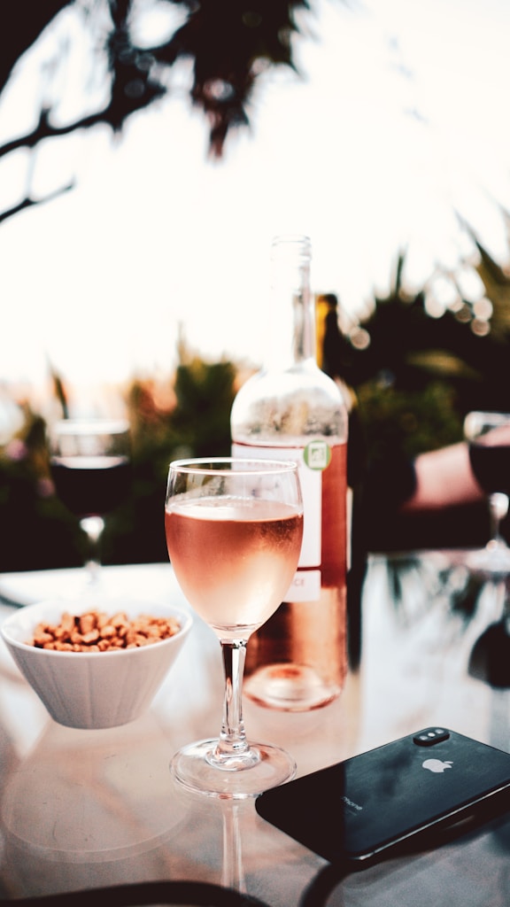 clear wine glass with brown liquid inside