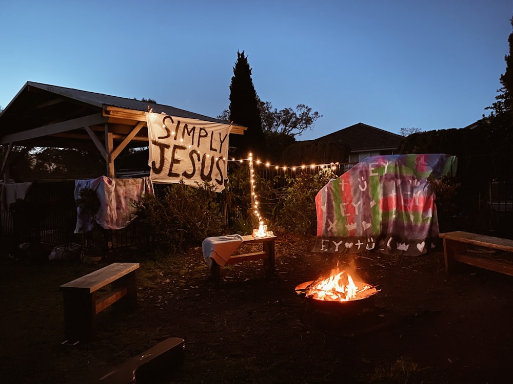 lighted bonfire near lighted house during night time