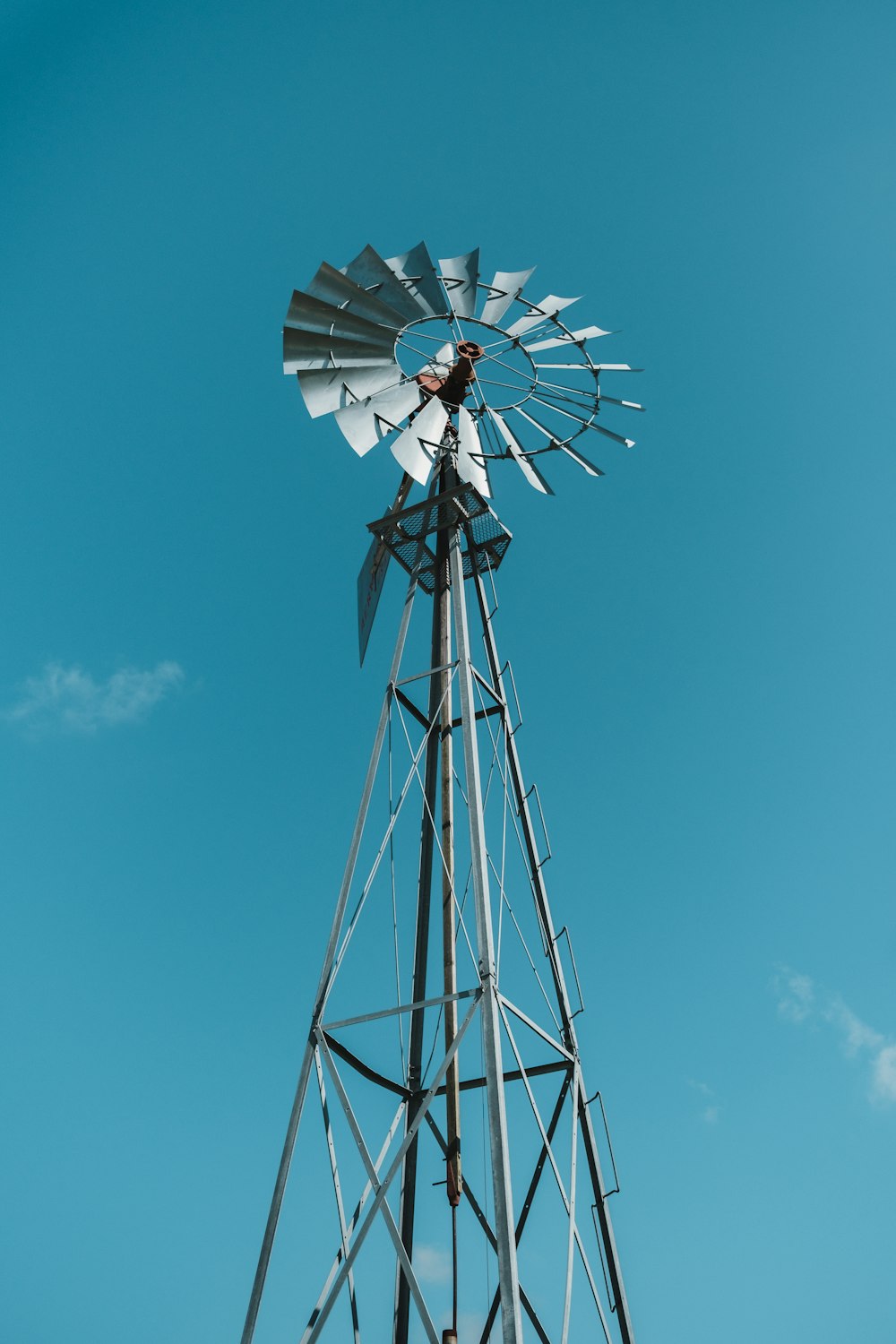 white and black windmill under blue sky during daytime