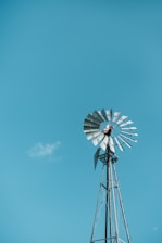 white and black windmill under blue sky during daytime
