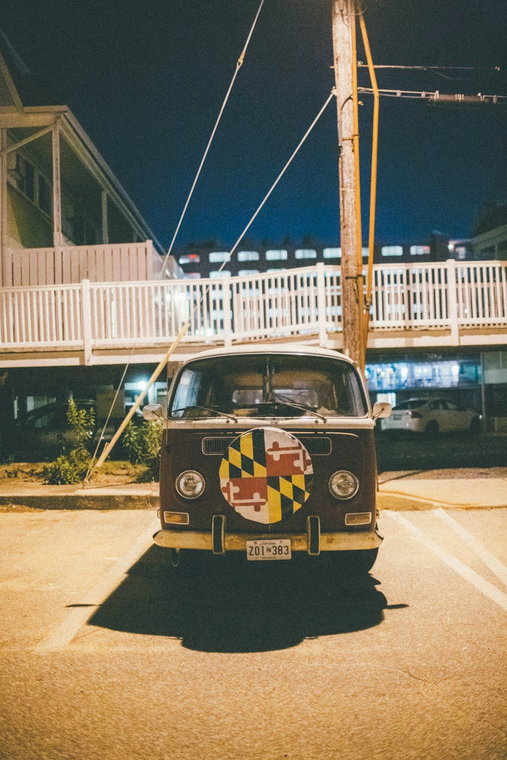 blue and yellow volkswagen t-2 van parked on the side of the road during daytime