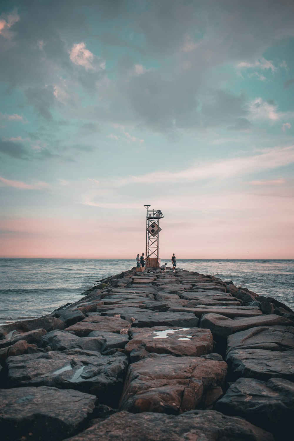 brown wooden dock on sea under cloudy sky during daytime