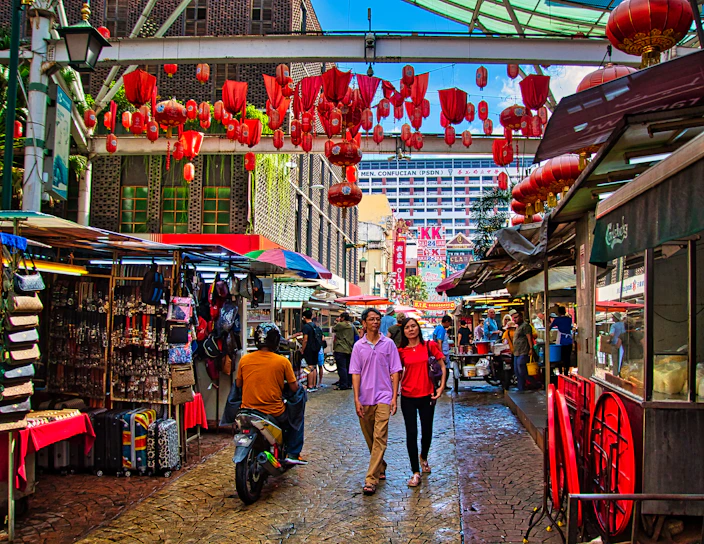 A bustling street market in Hanoi with colorful lanterns and local vendors selling fresh produce.