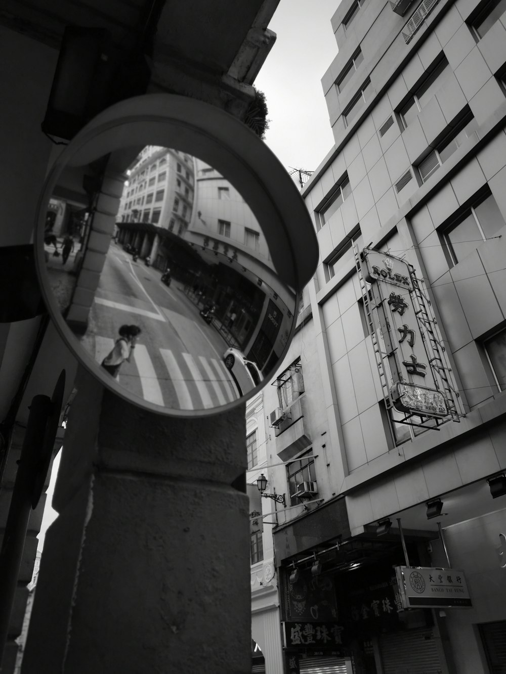 grayscale photo of round mirror