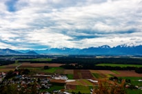 A scenic view of rural properties in the Chilean countryside with mountains in the background.