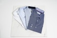 blue button up shirt on white table