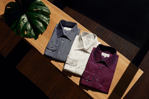 white button up shirt on brown wooden table