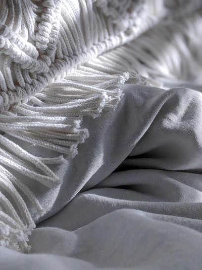 Close-up of a mattress corner showing the smooth, quilted fabric texture.