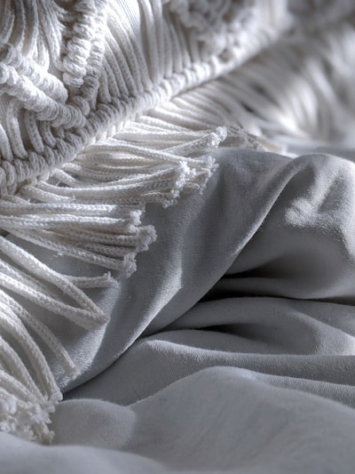 Close-up of a warm, knitted blanket with intricate patterns in earthy tones.