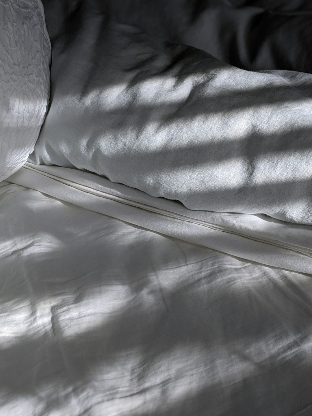 white textile on white textile