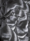 An abstract close-up of textured fabric folds creating shadow patterns.
